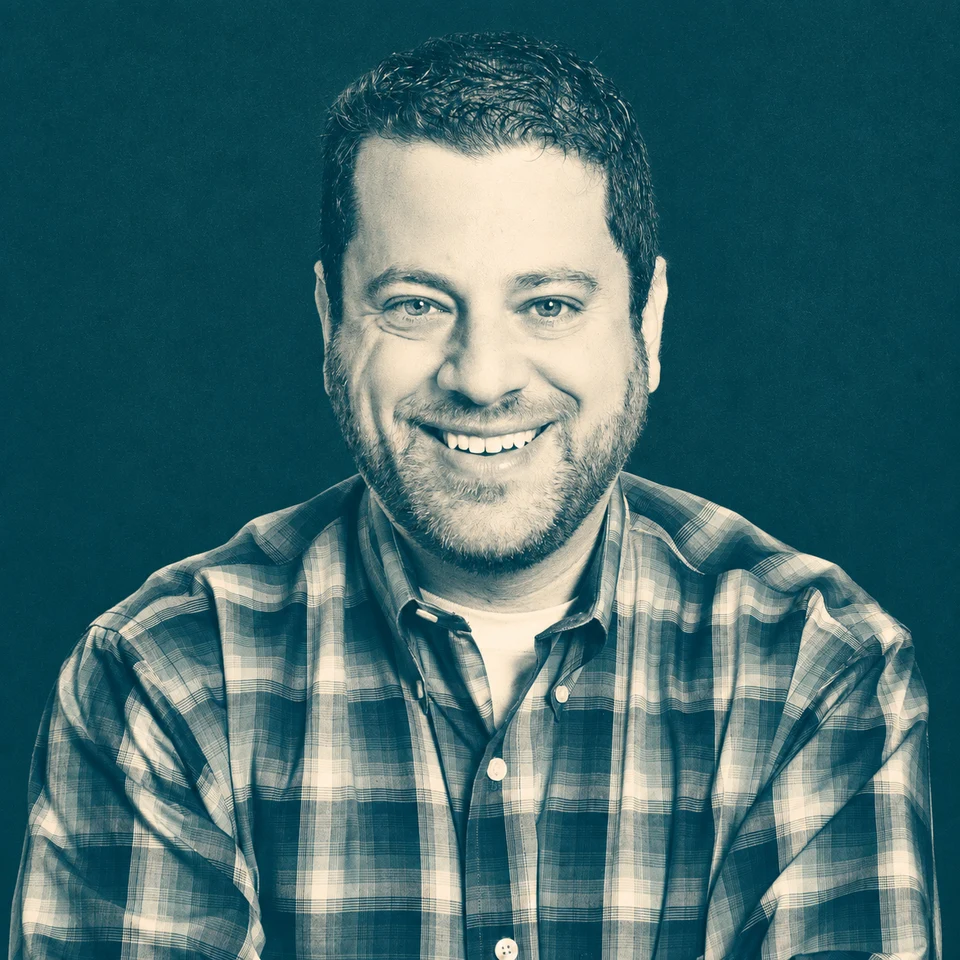 Harlan Landes in a petrol-and-ivory duotone studio portrait